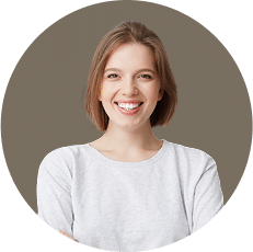 A smiling person with short, light brown hair wearing a light gray shirt against a gray circular background.